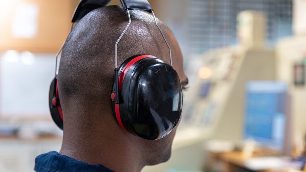 Officer with hearing muffs on to prevent becoming a statistic for veterans and hearing loss.