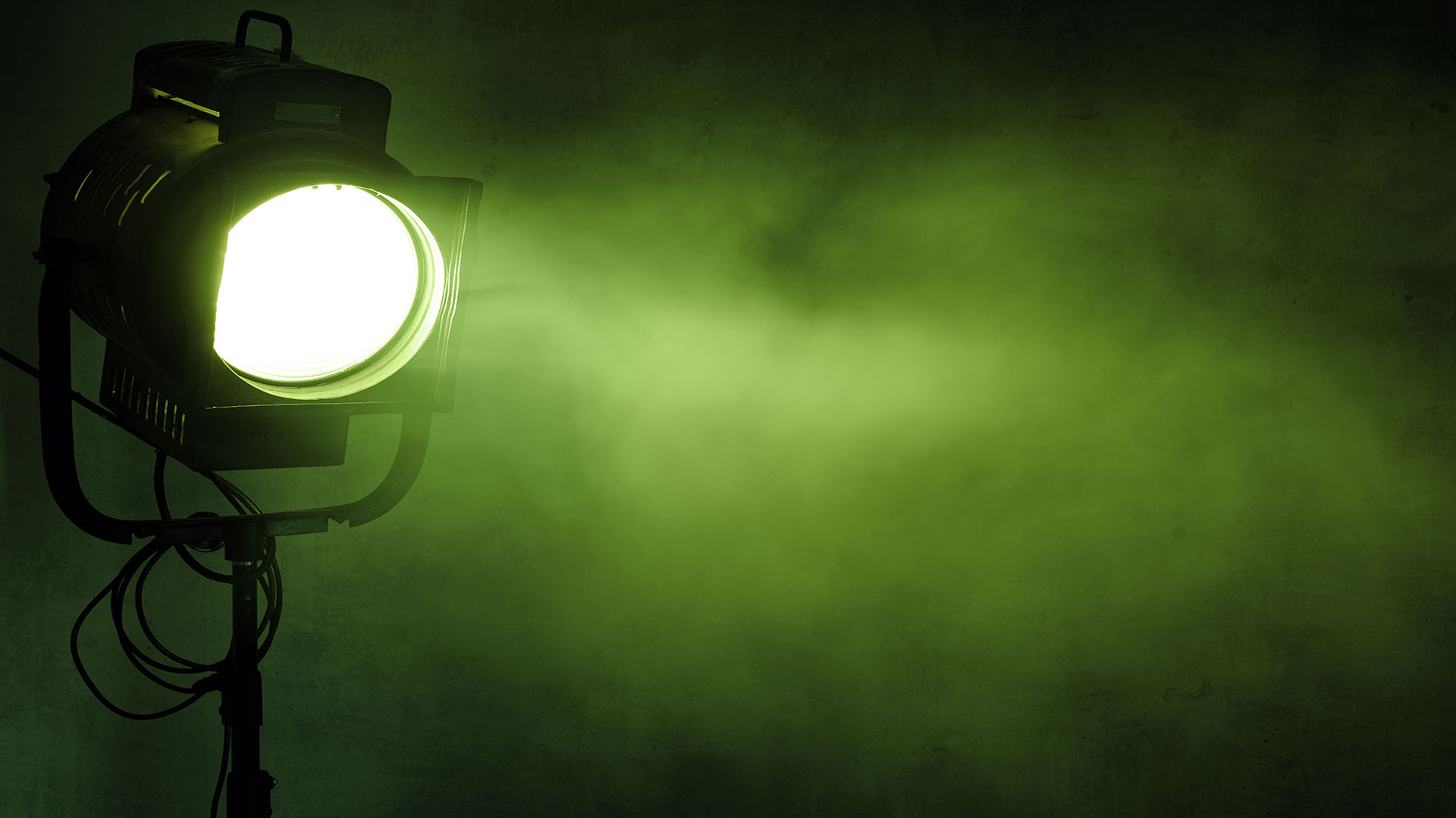theater spot light with smoke against grunge wall