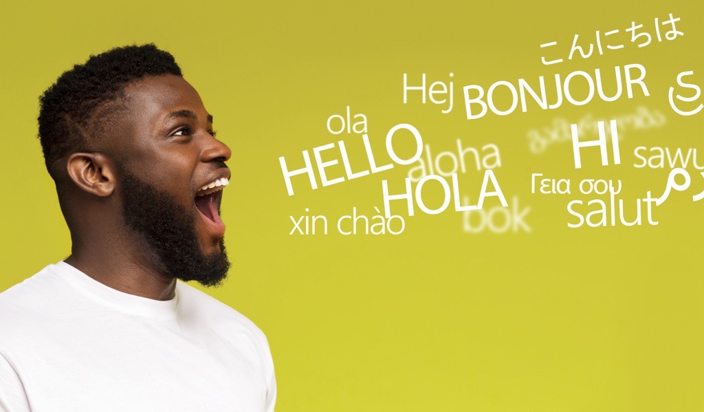 Black man has his mouth open, as if speaking. Text near his face says the word “Hello” in different languages.